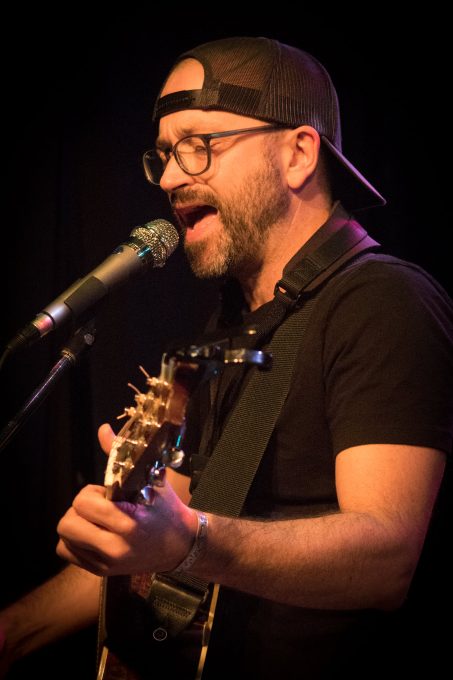 Trevor Ras playing guitar at Skylark Cafe